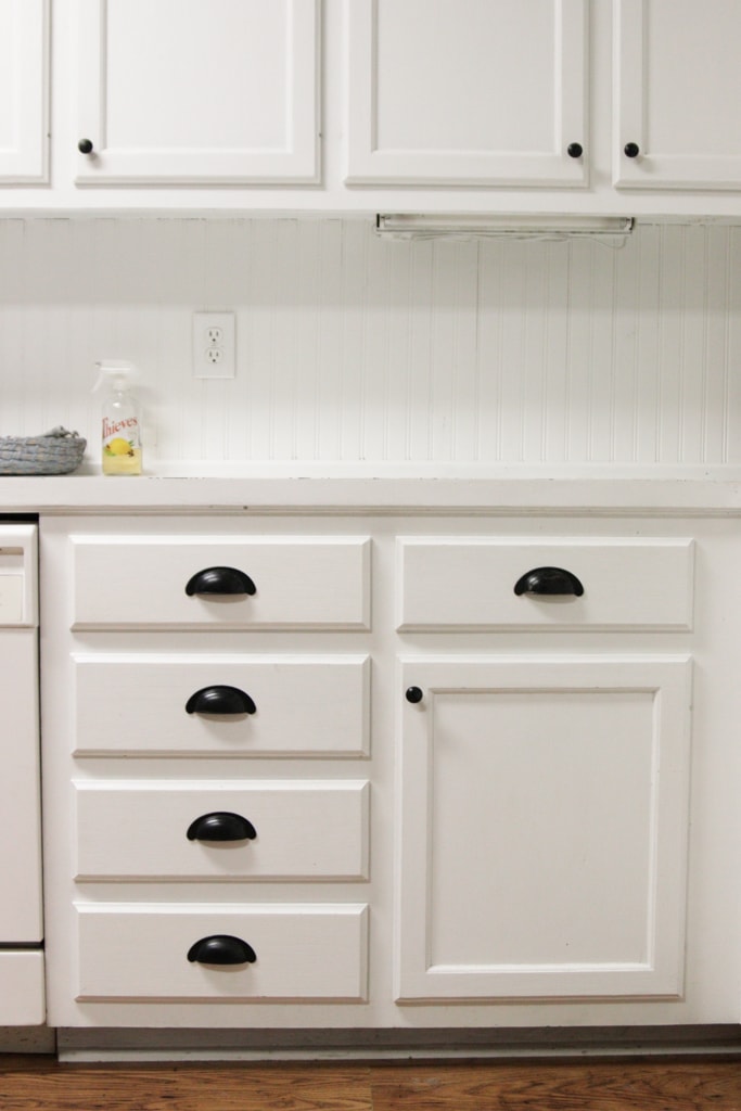 All white kitchen cabinets with black painted hardware