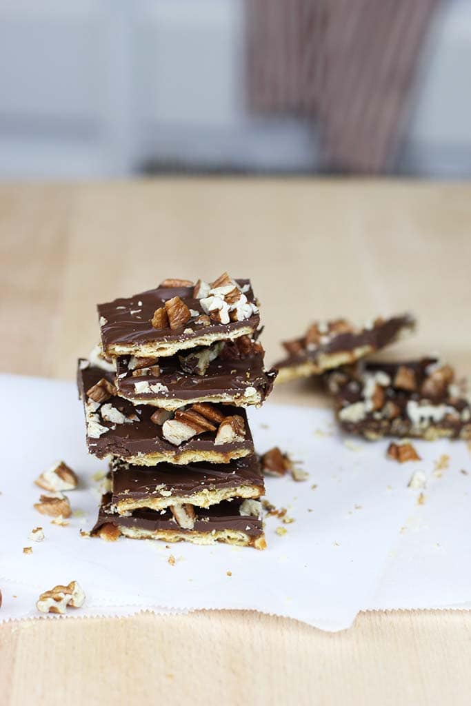 stack of saltine cracker toffee on parchment paper