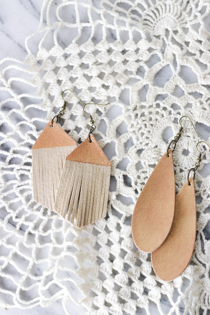 2 pairs of leather earrings on a white crocheted doily