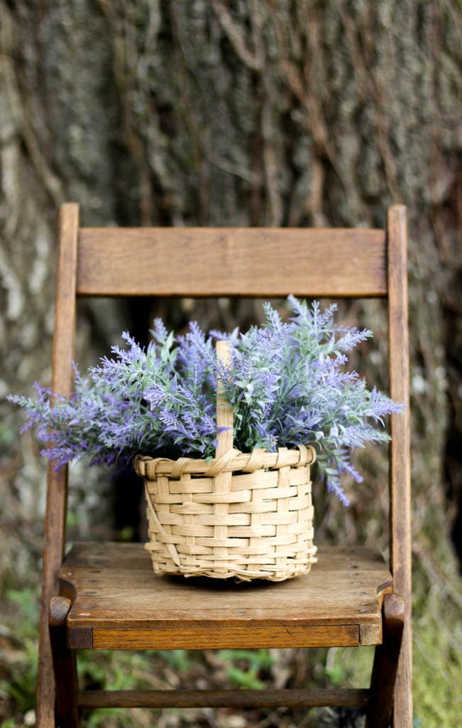 small white oak basket with lavender on an antique folding chair